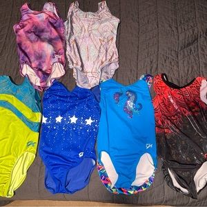 5 GK leotards, one unknown brand. 4 on bottom are CL 2 on top are CM